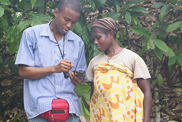 Staff training a farmer on use of equipment