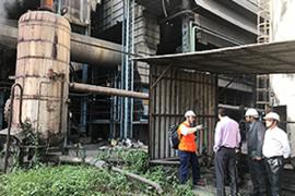 Experts conducting walk-through survey at a recycle paper company