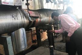 Staff of the textile company monitoring the condition of the steam trap