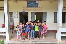 School children greeting IGES during the handover of waste tools at Donekheo Primary School